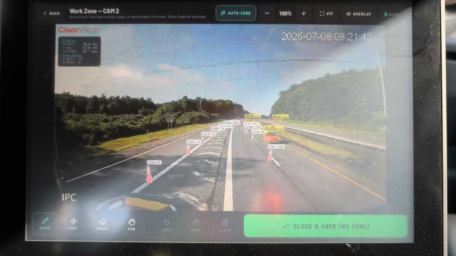 The in-cab touchscreen adjusting the work zone boundary on a live truck camera